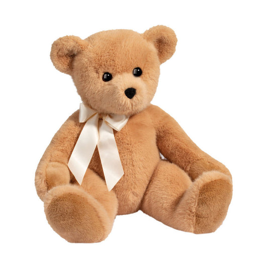 This is Graham by Douglas Cuddle Toys. Graham is a sitting teddy with short, dense beige fur that appears slightly glossy. The muzzle is a similar but slightly lighter beige, the inner ears match the beige fur, the tummy and paws are beige and the paw pads are not visibly distinct from the fur. Eyes are black and round, the nose is black and small with a rounded triangular shape. There are no distinct markings. He wears a cream satin ribbon tied in a bow at the neck. The pose is seated and non-jointed,...