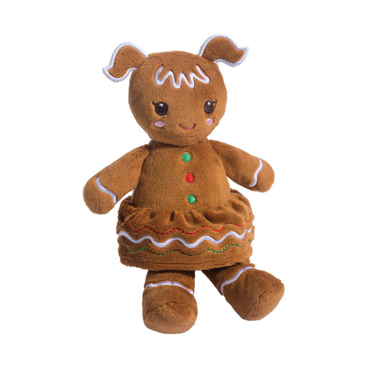 This is Gingerbread Girl by Douglas Cuddle Toys. Standing gingerbread character with short, even brown fur that appears matte and dense; fur colour is brown overall with small pink embroidered cheek spots. Head has two wavy ear-like protrusions edged with white piping and white icing-like embroidery across the forehead. Eyes are dark brown and round with small white highlights, and there is no visible separate nose; mouth is a small curved pink embroidered smile. Body shows a ruffled skirt with wavy em...