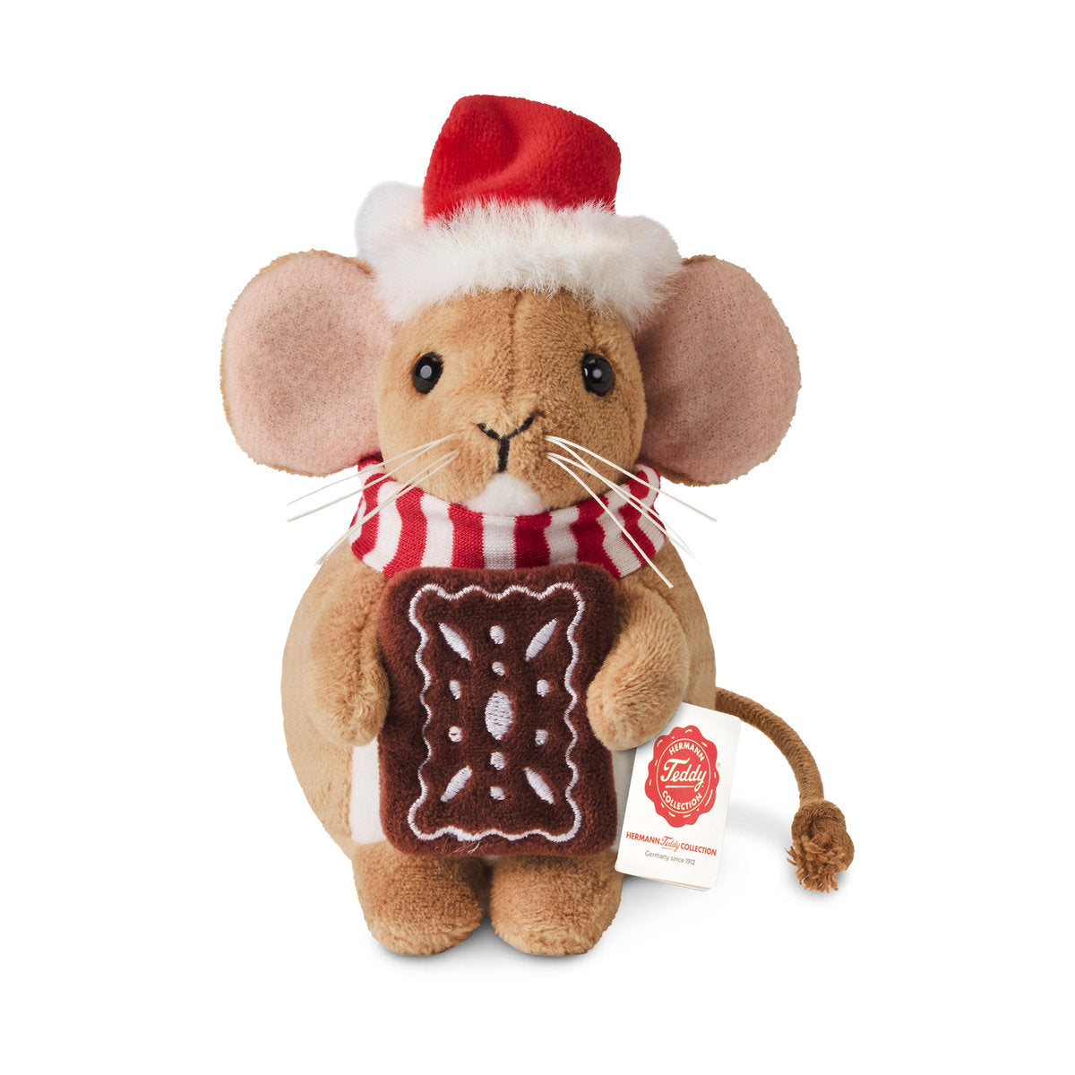 This is Small Christmas Mouse With Gingerbread Cookie by Teddy-Hermann. Small mouse with short, dense, softly lustrous brown fur and a white fur tummy patch and small white chin. Muzzle is brown with a tiny white chin area, inner ears are pale pink, paws are brown and paw pads match the brown fur. Eyes are black and round; nose is black and stitched triangular. There is a white whisker cluster at each side of the muzzle. Markings include the white tummy patch and white chin. The plush sits upright, hol...