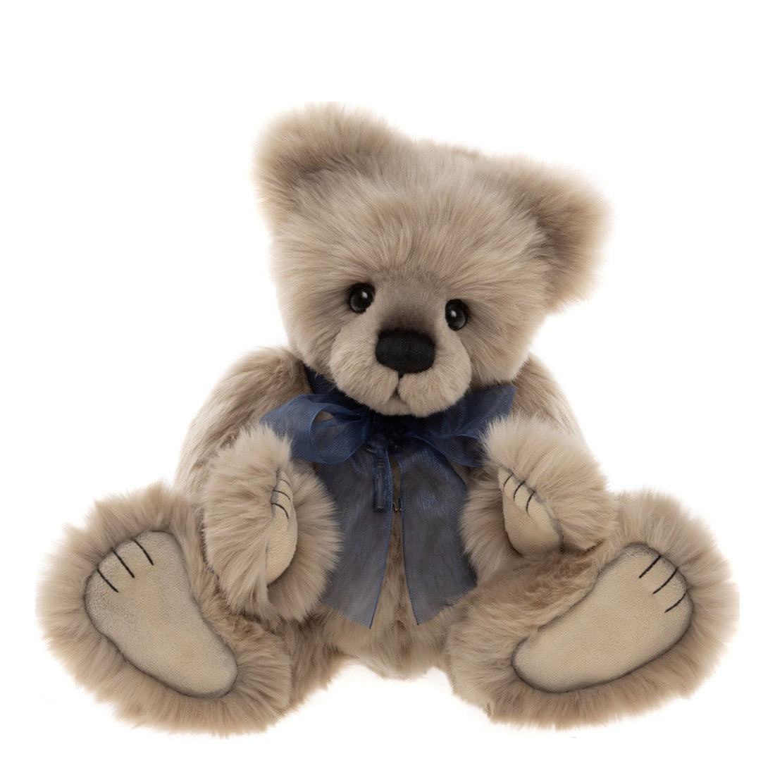 This is Howarth by Charlie Bears. Sitting teddy with long, dense, slightly silky fur that appears beige with a faint gray cast in shaded areas; the fur is straight with a soft sheen and looks thick around head and limbs. Muzzle is a slightly darker gray-beige, inner ears match the beige fur, tummy matches the main beige fur, paws are beige and paw pads are smooth beige. Eyes are black and round; nose is black and oval with a stitched black vertical mouth line. No distinct markings such as stripes or pa...