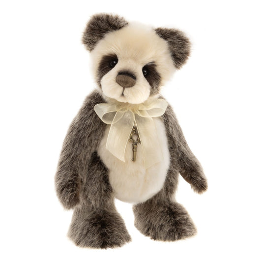 This is Ticklish by Charlie Bears. Plush bear shown alone, made of plush with long, slightly shaggy fur that has a soft sheen; fur on head and tummy is short and smoother while arms, legs and ears are longer and fluffy. Fur colours are white on the forehead, muzzle and tummy, with gray fur across the ears, arms, legs and around the eyes, and brown shading on the nose and eye patches. Muzzle is cream-white and rounded, inner ears and paw tops are gray, paw pads are dark brown, eyes are black and slightl...