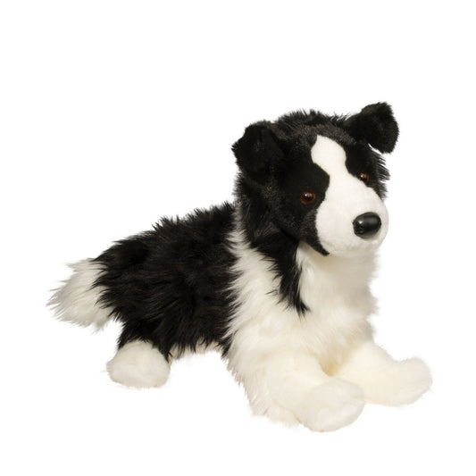 This is Chase by Douglas Cuddle Toys. Chase is a border collie dog plush shown lying on its belly with front legs extended and rear legs tucked to the side. The fur is black and white, medium-long, slightly shaggy with a low sheen. The muzzle is white and rounded; the ears are black, upright with slightly rounded tips and black inner ear fur; the tummy and front paws are white and plushy; the rear paws are white; paw pads are not visible. The eyes are brown and round; the nose is black and smooth and o...