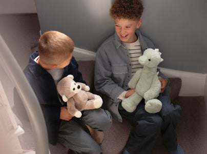 Boys on the stairs with Cheeky Monkey and Stevie Stegosaurus