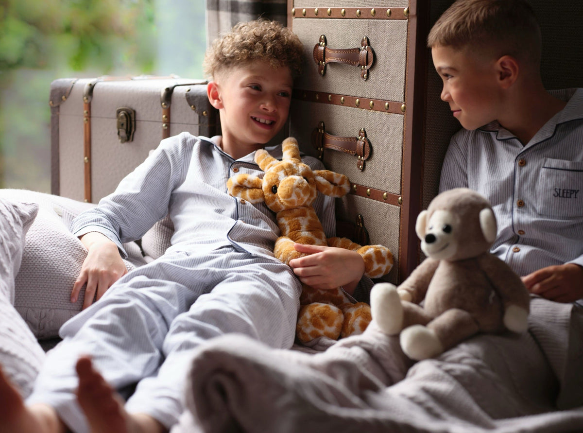 Boys in pyjamas with Gilbert Giraffe and Cheeky Monkey