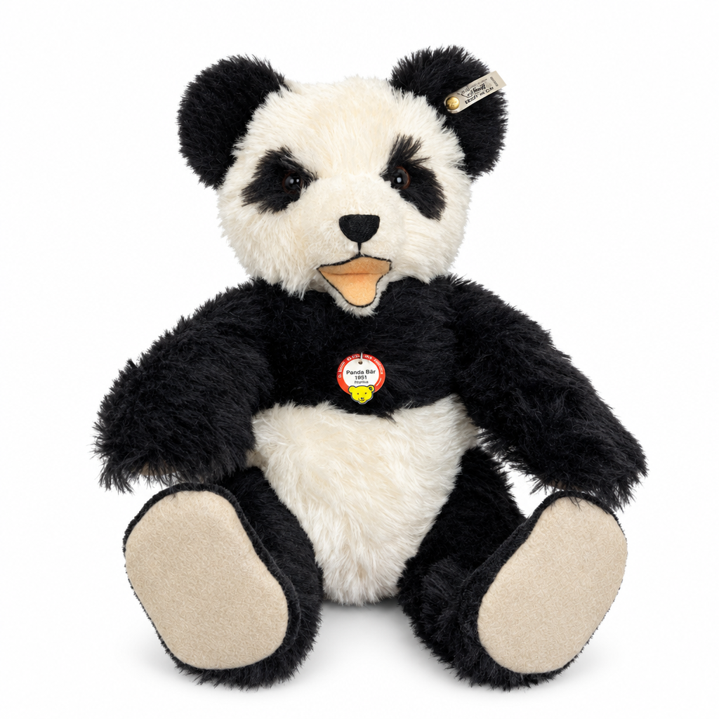 This is Panda Bear 1951 Replica by Steiff. Large panda with a shaggy, medium-length fur that appears slightly lustrous and dense. Fur colours are black on the ears, eye patches, arms, legs and shoulders, and white on the face centre, tummy and inner chest; paw pads and the visible sole areas are beige. Muzzle is white with a small black triangular nose and a short black vertical stitch down from the nose. Eyes are dark brown and set within black eye patches. Mouth is open showing a beige/orange tongue ...