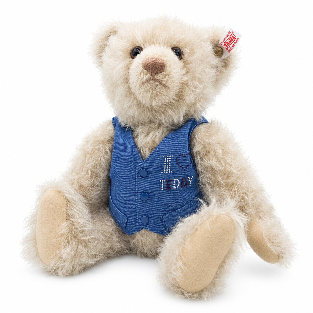 This is Crystal Bear by Steiff. Sitting bear with a slightly shaggy, curly look to the fur that appears soft and moderately long with a low sheen; the fur is beige overall with slightly darker beige/brown shading on the muzzle and around the eye rims. The muzzle is light brown and rounded, the inner ears match the beige fur, the tummy and limbs are covered in the same beige fur, and the paw soles and paw pads are a tan beige. Eyes are dark brown and round, the nose is brown and triangular. The bear wea...